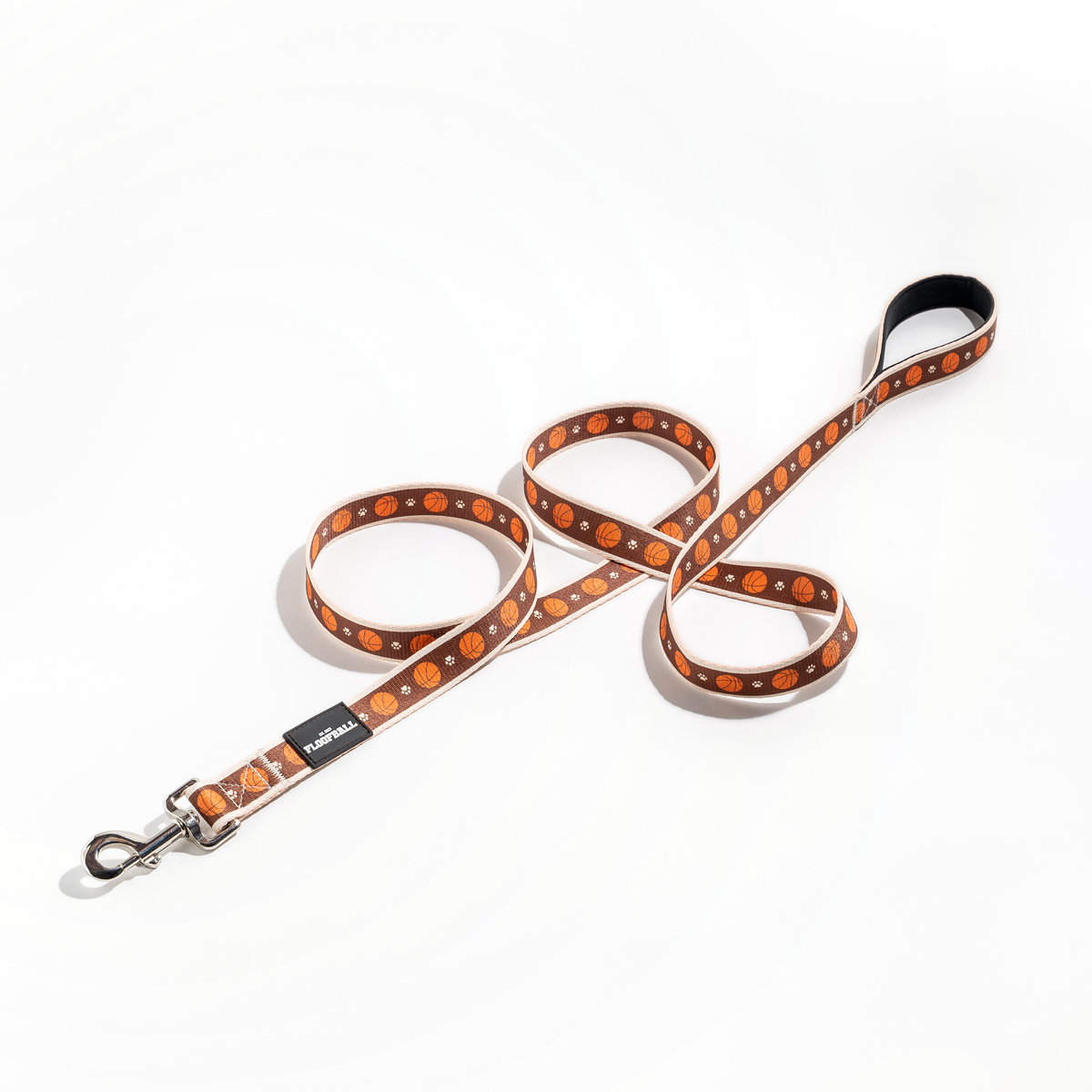Full Floofball basketball dog leash laid out on a white background with padded handle, basketball print and metal hardware.
