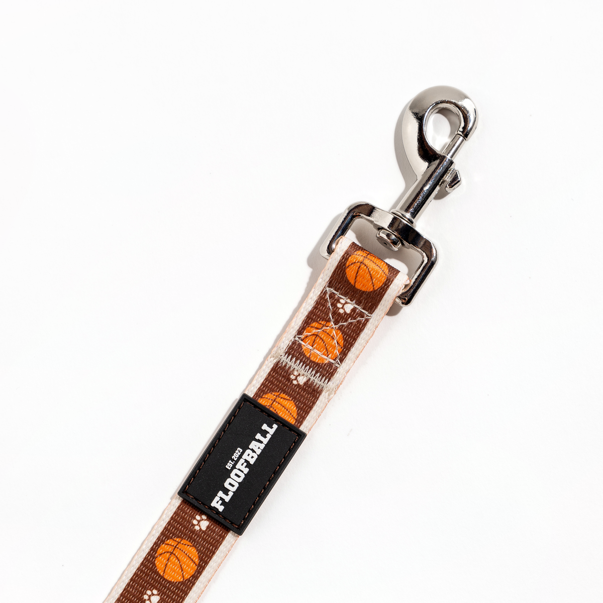 Close-up of the Floofball basketball dog leash with metal clasp, reinforced stitching and Floofball logo patch.