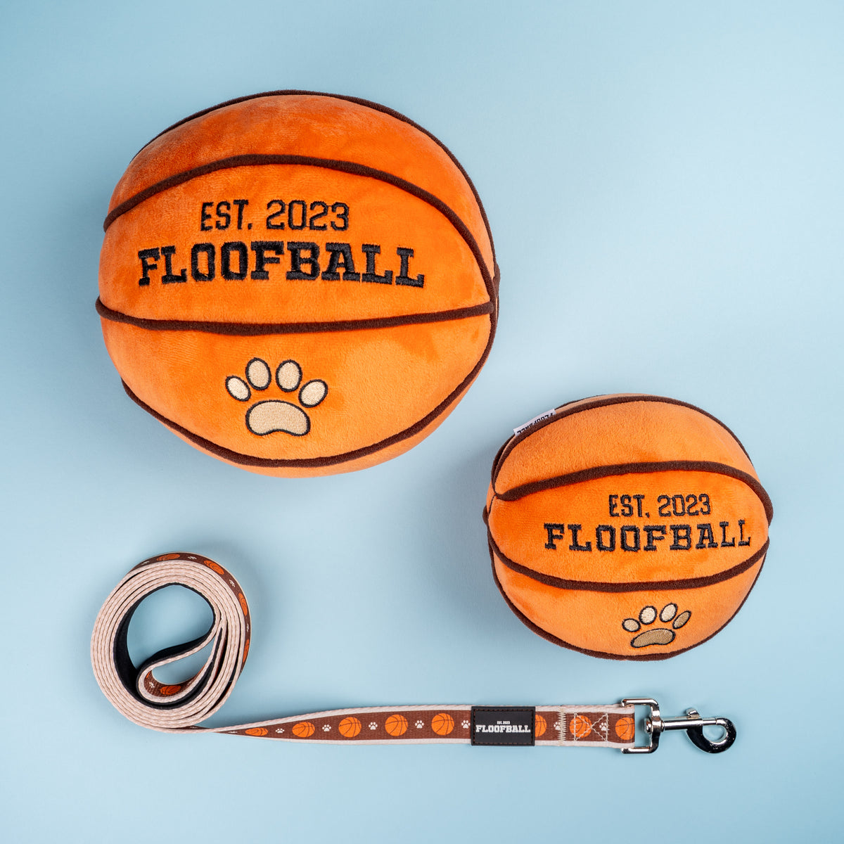 Floofball basketball dog collection featuring plush basketball dog toys and a coordinating basketball print dog leash.