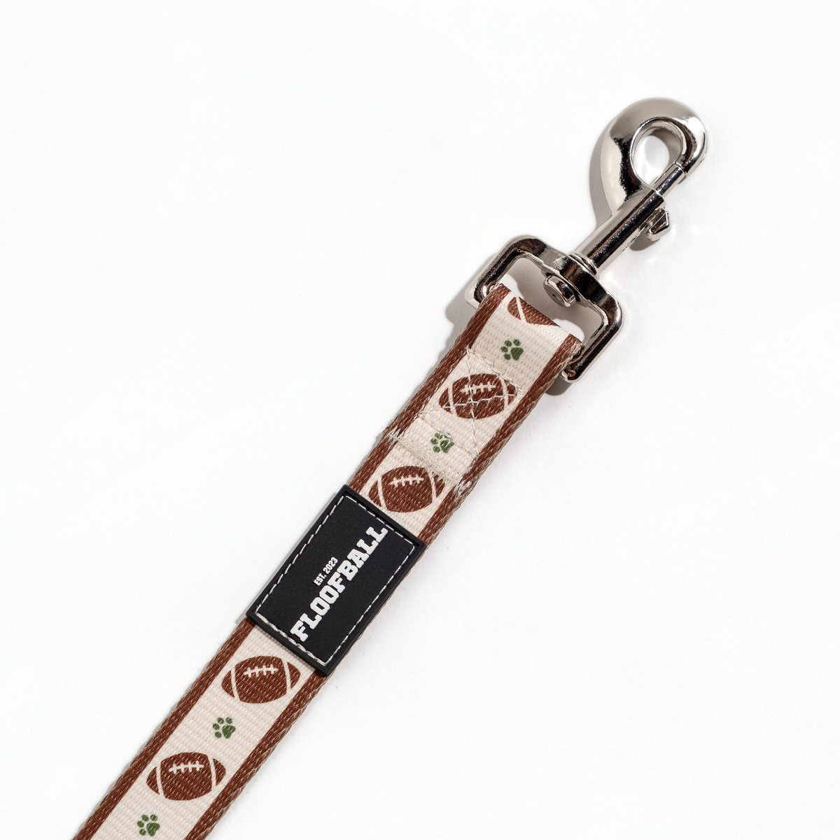 Close-up of the Floofball football dog leash featuring durable metal hardware and football-inspired detailing.