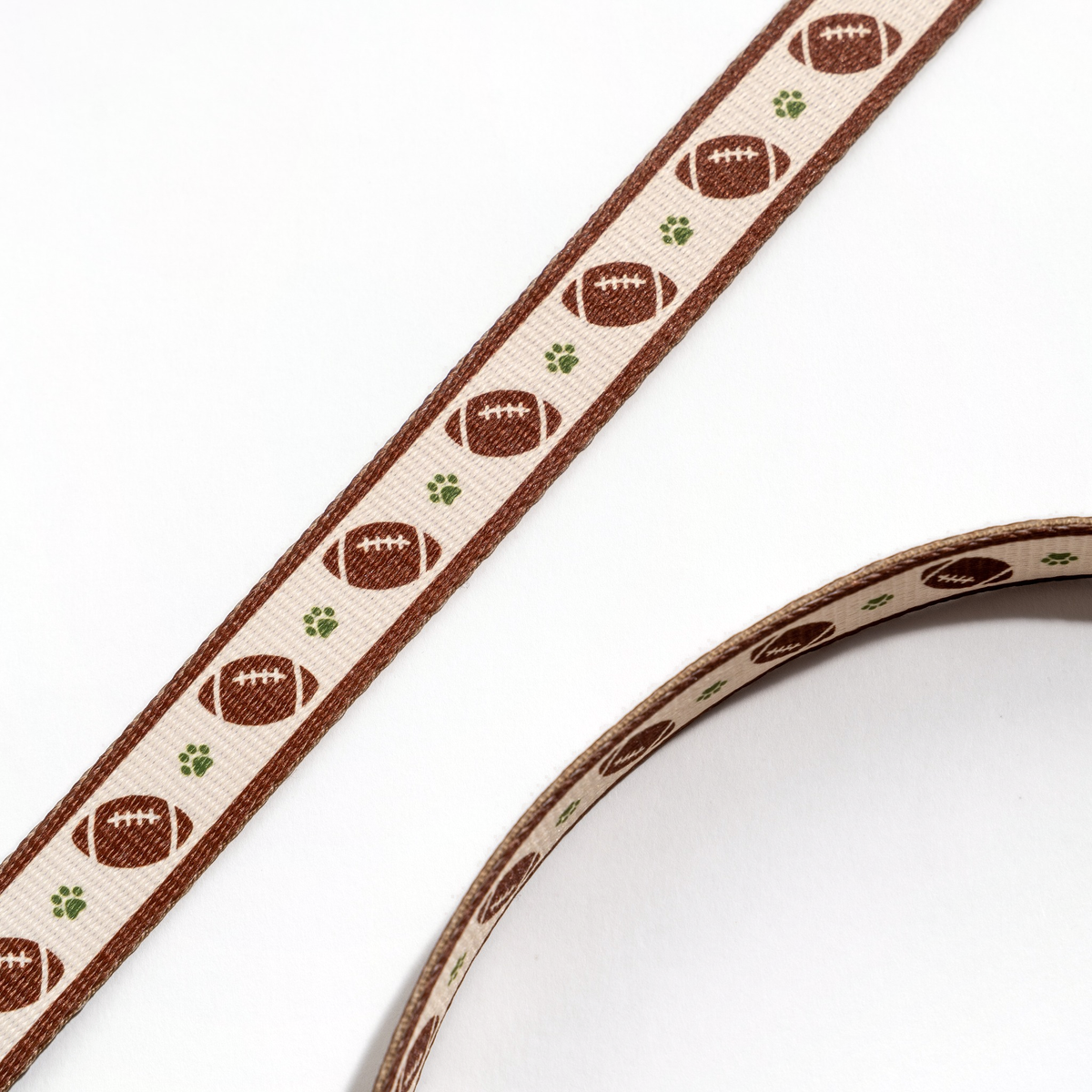 Close-up of the Floofball football dog leash showing its football-inspired pattern and tight reinforced stitching.
