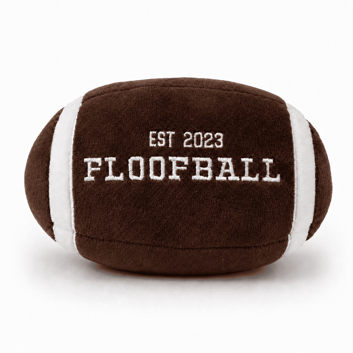 Front view of the Floofball plush football dog toy featuring embroidered EST. 2023 FLOOFBALL lettering.