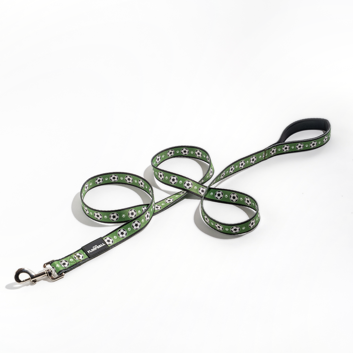 Full Floofball soccer dog leash laid out on a white background with padded handle, soccer print and metal hardware.
