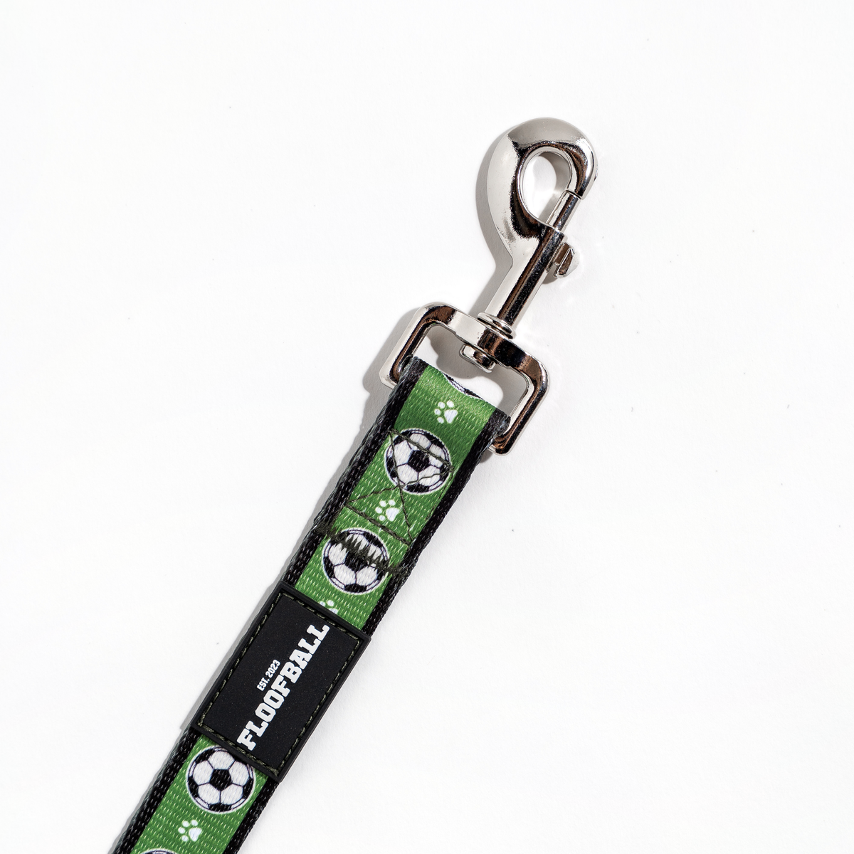 Close-up of the Floofball soccer dog leash with metal clasp, reinforced stitching and Floofball logo patch.