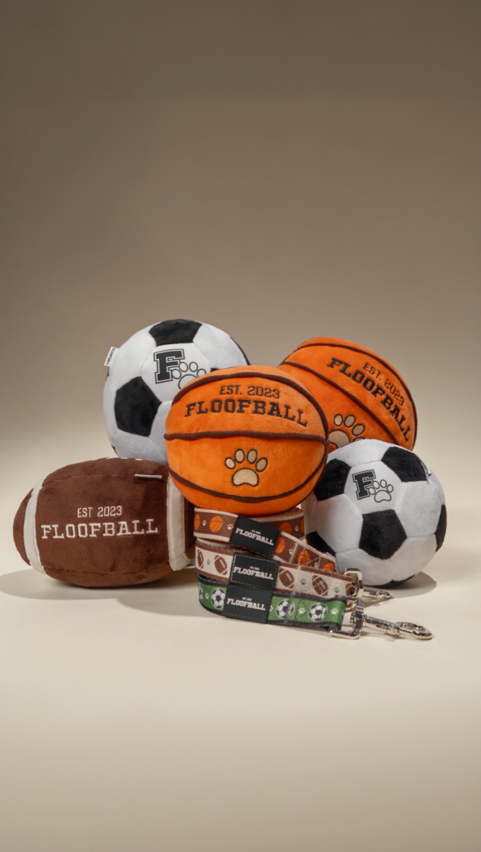 Floofball sports dog toys and leashes featuring plush soccer balls, basketball, football, and coordinating sport-inspired dog leashes.